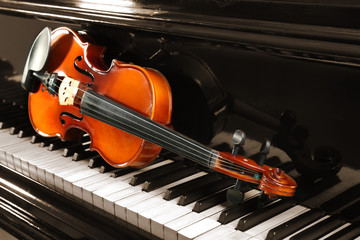 Violin on piano keys, closeup