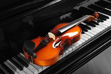 Violin on piano keys, closeup