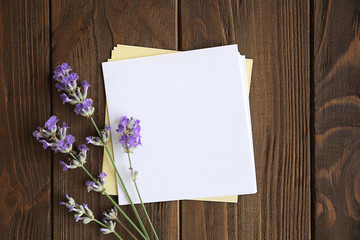 Lavender with paper on wooden background