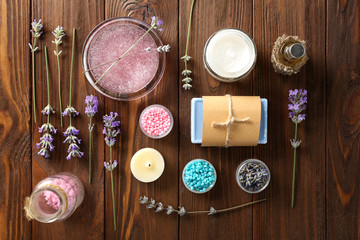 Lavender with soap, sea salt and candle on wooden background. Treatment concept