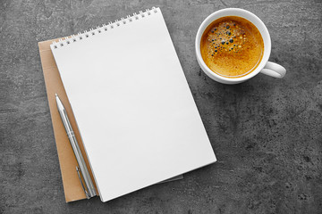 School notebook with coffee on table