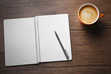 School notebook with coffee on table