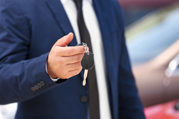 Male hand with car key outdoors