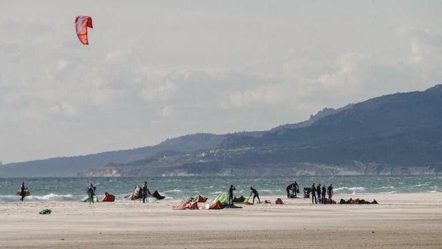 large beach filled with kite surfers