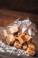 Sweet caramel candies. Salted caramel pieces and sea salt close
