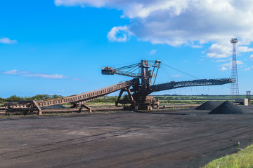 Fototapeta na wymiar Loading iron ore conveyor machine in steel industry, UK