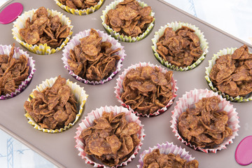 Close up image of homemade chocolate cereal cakes in a baking tray 