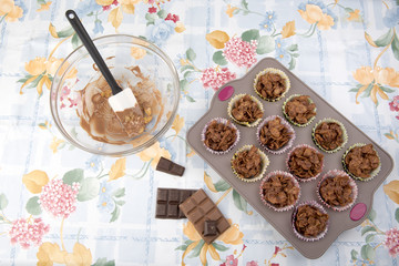 Image of homemade chocolate cereal cakes in a baking tray with a mixing bowl.