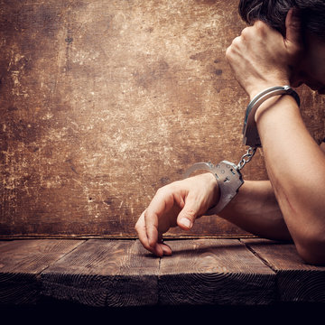 Male Hands In Handcuffs