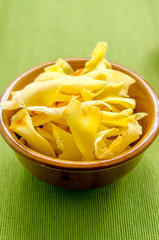 Durian chips fried snack fruit in brown blow on green background