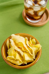 Cola and durian chips fried snack fruit in brown blow on green b