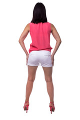 Beautiful, attractive young woman in blouse and short shorts with an elegant figure, buttocks, ass, standing backwards