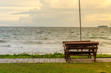 Fototapeta na wymiar An empty wooden bench in sunset time