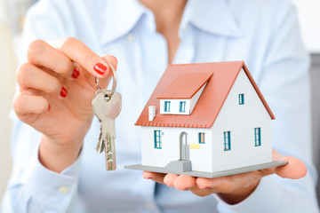 Real estate agent hand over property or new home keys to a customer - 117381976