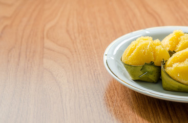 Toddy Palm Cake with coconut in white dish on wooden background: