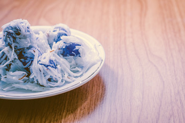Thai dessert Coconut munchkins in white dish on wooden backgroun