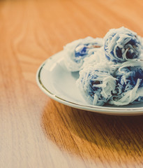 Thai dessert Coconut munchkins in white dish on wooden backgroun
