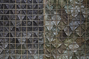 Dried leaves fence. Dried leaves fence on traditional wall. The dried leaves use as barrier wall or panal for the house. Decoration Retro Styled. Dried leaves fence for cottage wall.