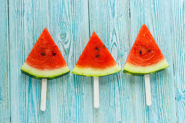 fresh slices of ripe watermelon at wooden background