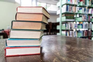 Old books on wooden table in library, education and learning 