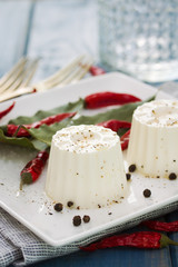 fresh cheese with pepper on white plate
