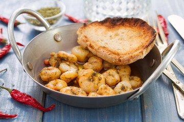 fried shrimps with bread on dish on blue background
