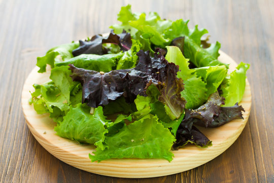 salad on wooden dish on brown wooden background