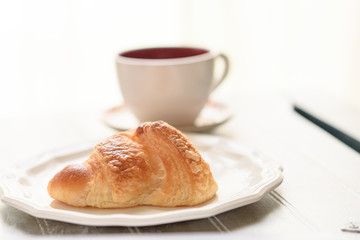Croissant and coffee cup