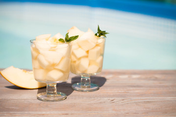 Melon juice in the jar on the wooden table