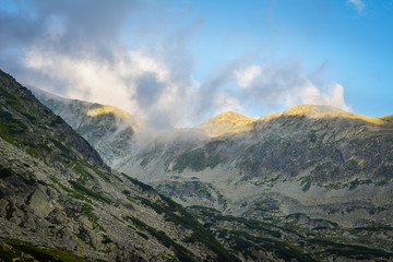 Obraz na płótnie Canvas Carpathian Mountains in Romania. Clouds, blue sky, cliffs.