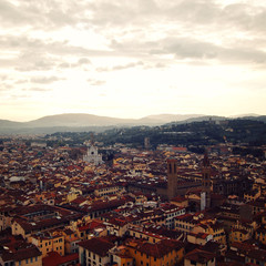 Roofs of Florence from belfry. Aged photo. View of Firenze city with Basilica of Santa Croce in the distance. To the east from Campanile of Florence Cathedral. Sunrise. Italy.