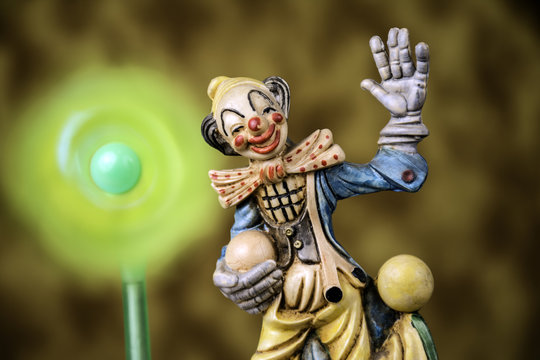 figurine of juggling circus clown with spinning pinwheel