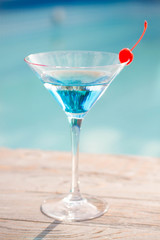 Blue cocktail with a cherry