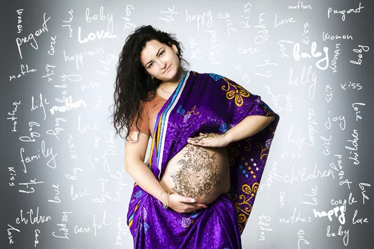 studio portrait of a pregnant woman in Indian sari, a pregnant