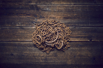 Tangle of rusty chains on wooden boards 