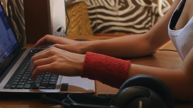 Teenage girl in her room working laptop