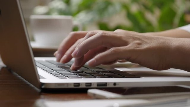Woman hands typing on the keyboard of laptop computer. Hight quality shot, UHD, 4K
