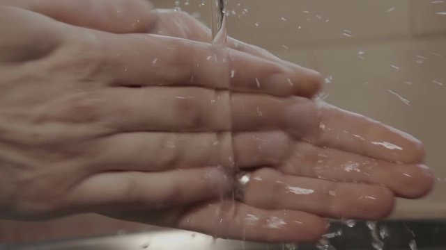 Male Washing Hands In A Domestic Kitchen. Super Slow Motion