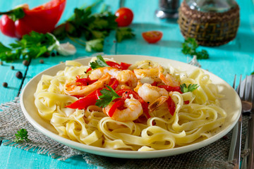 Italian pasta tagliatelle with shrimp and sweet peppers paprika,