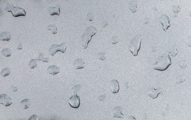  rain drops on a metal background of a car