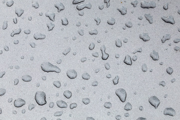 rain drops on a metal background of a car