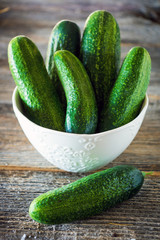 Organic cucumbers on wooden  background
