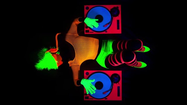 sexy DJ mixes in UV fluorescent costume