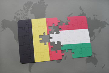 puzzle with the national flag of belgium and hungary on a world map background.