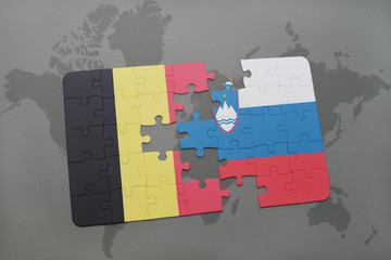 puzzle with the national flag of belgium and slovenia on a world map background.