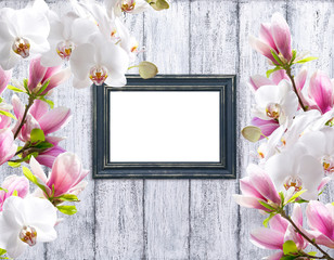 Magnolia flowers with orchidea and photo frame