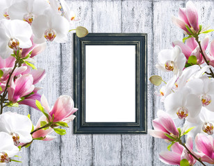 Magnolia flowers with orchidea and photo frame