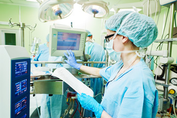 Surgery assistant perfusionist at modern heart lung machine