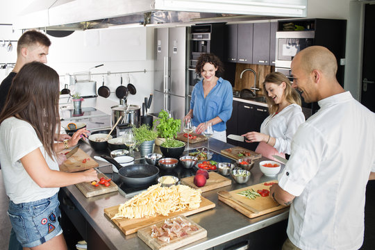 smiling people cooking together
