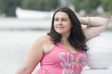 Pretty young woman outdoor in a relaxing pose